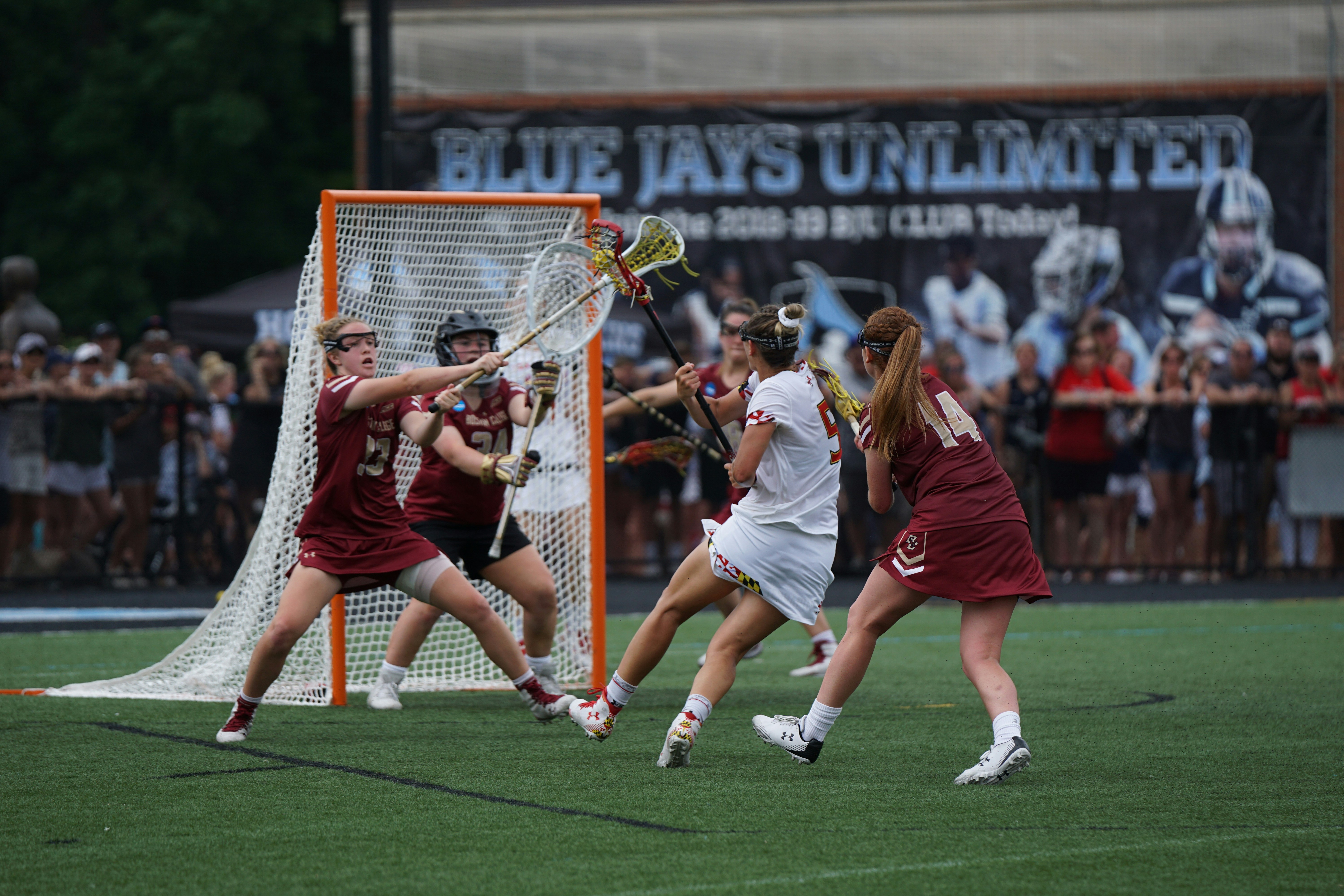 Lacrosse team in action around the goal