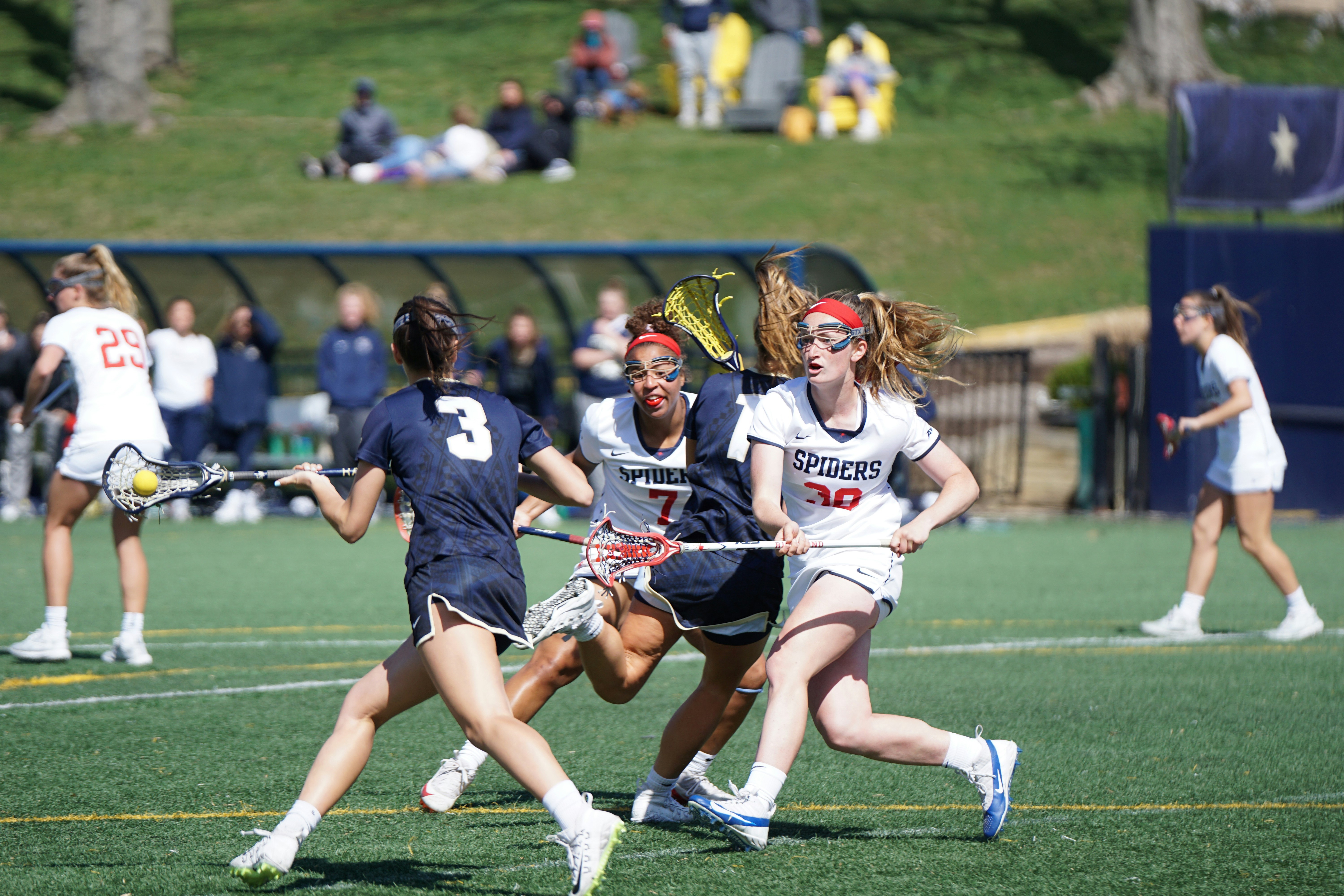 Lacrosse players battling for a ground ball