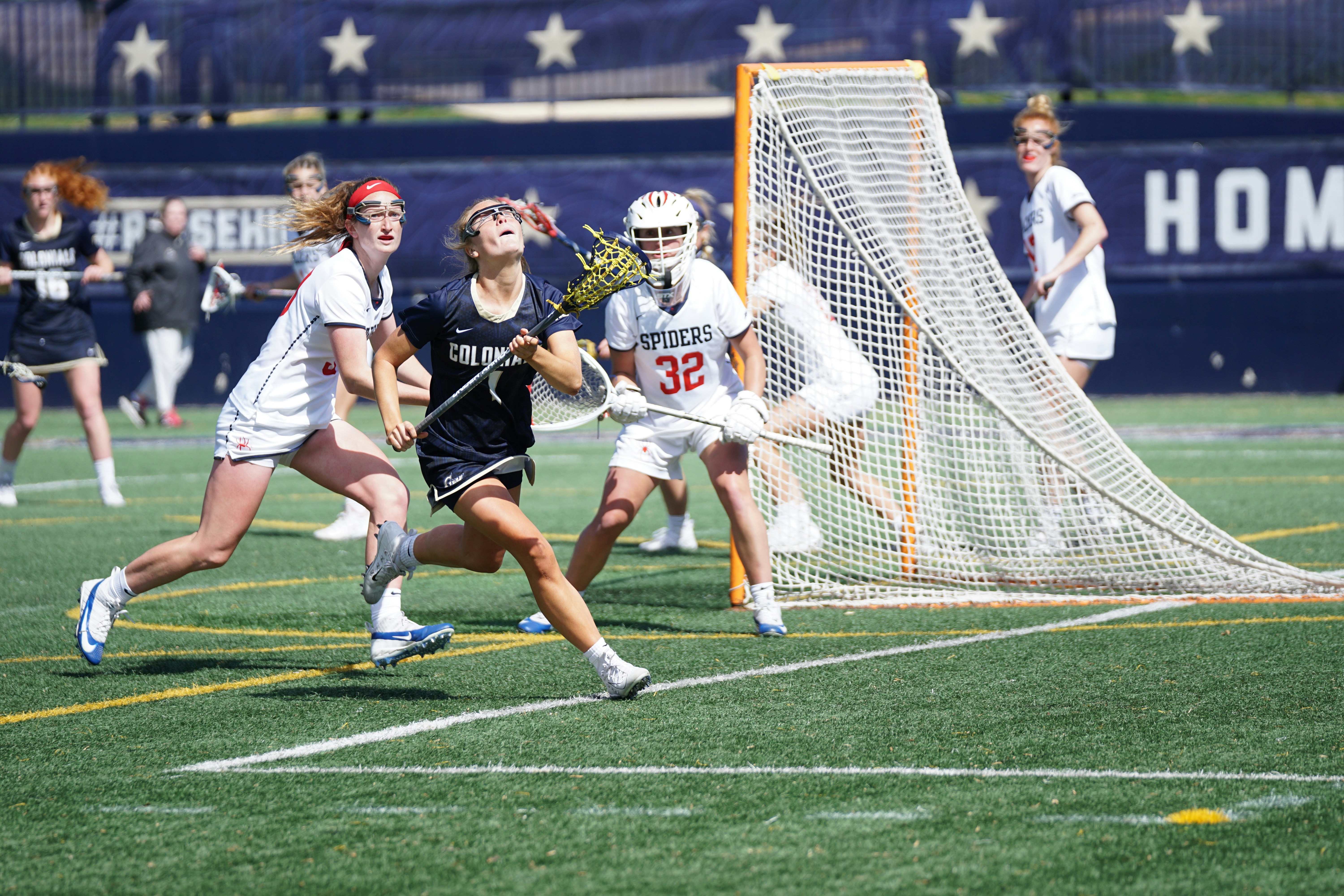 Girls lacrosse attacker driving on goalie